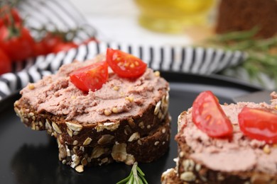 Photo of Delicious liverwurst sandwiches with tomatoes on table, closeup