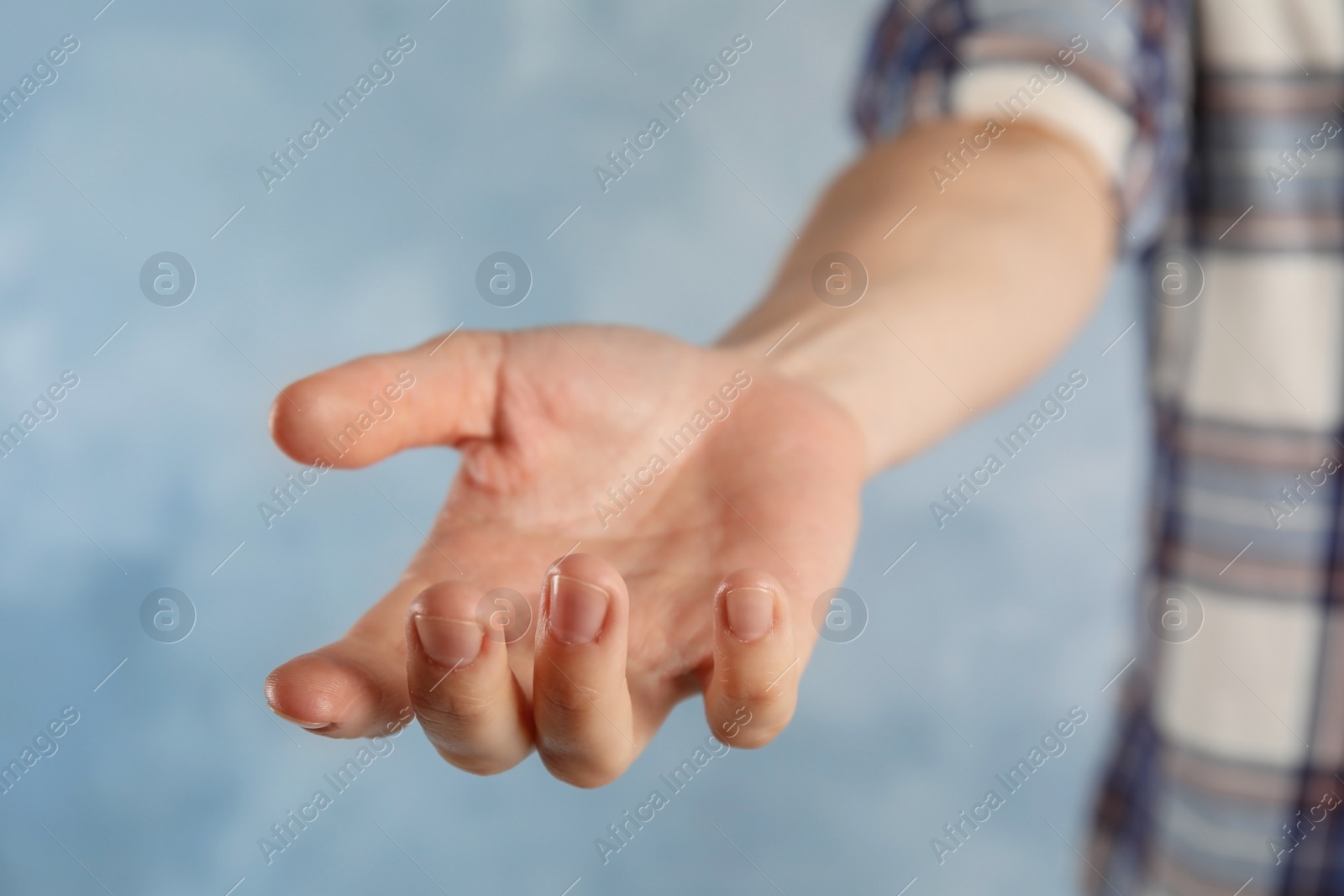 Photo of Woman offering helping hand on color background, closeup