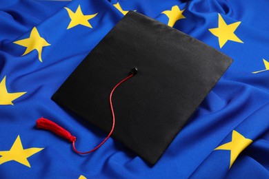 Photo of Black graduation cap on flag of European Union