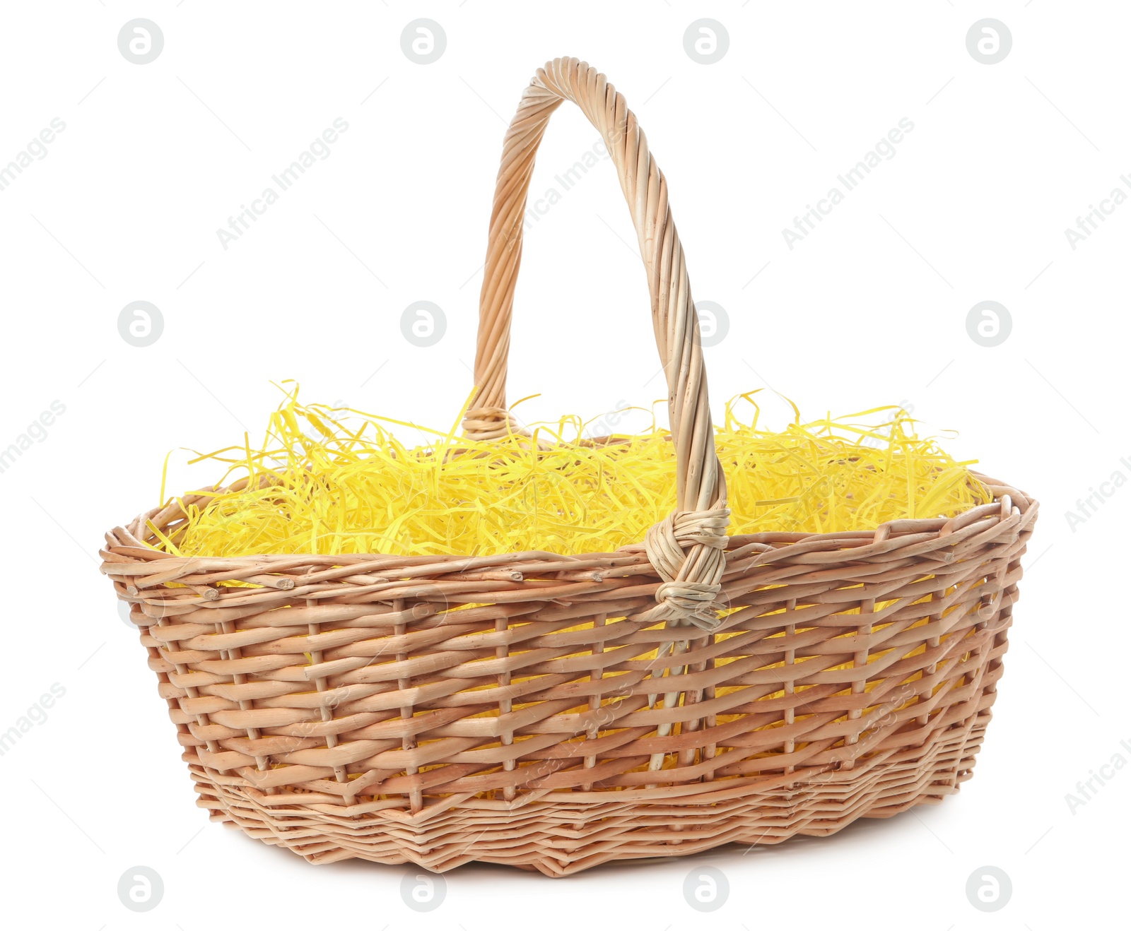 Photo of Wicker basket with yellow filler isolated on white. Easter item