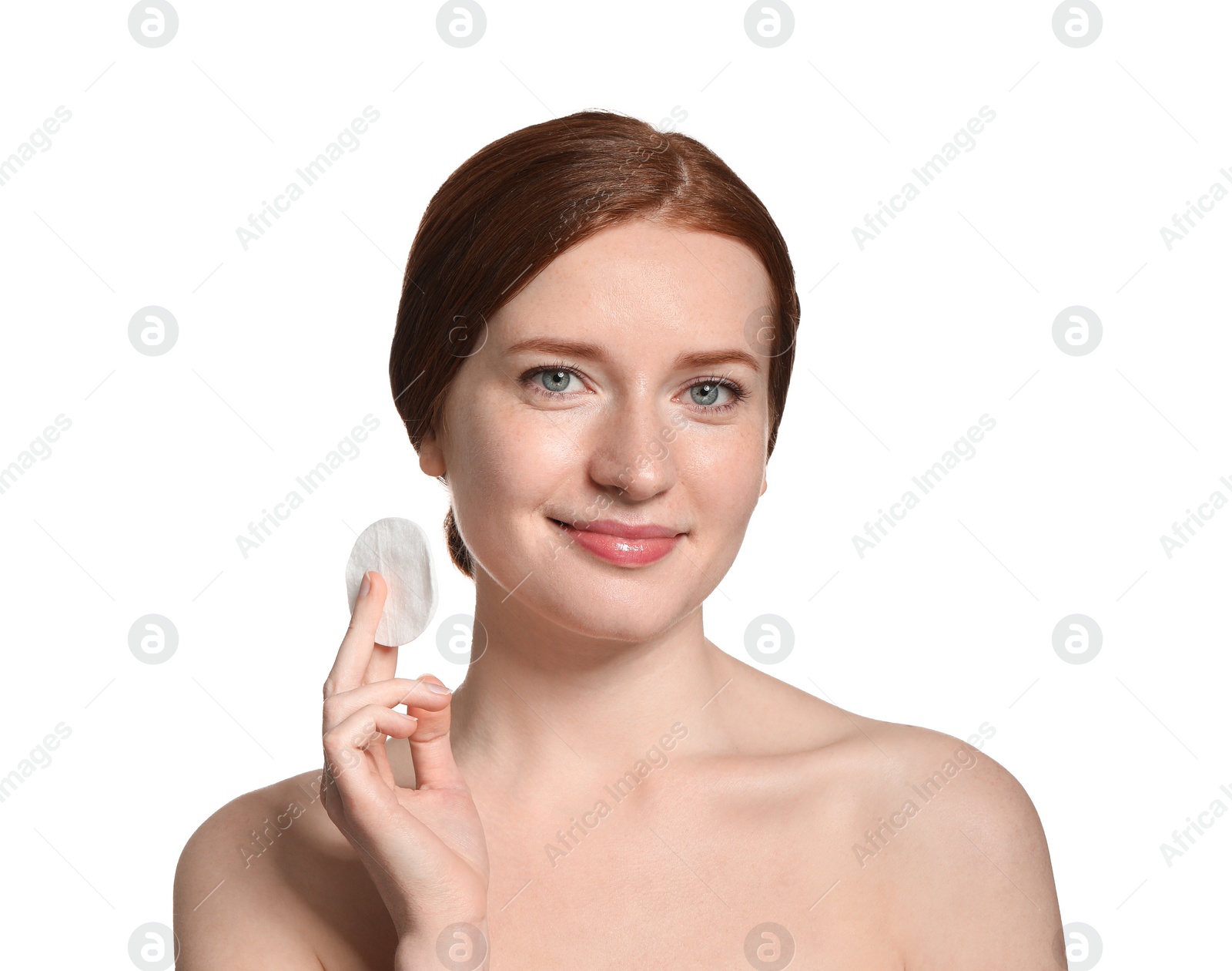 Photo of Beautiful woman with freckles holding cotton pad on white background