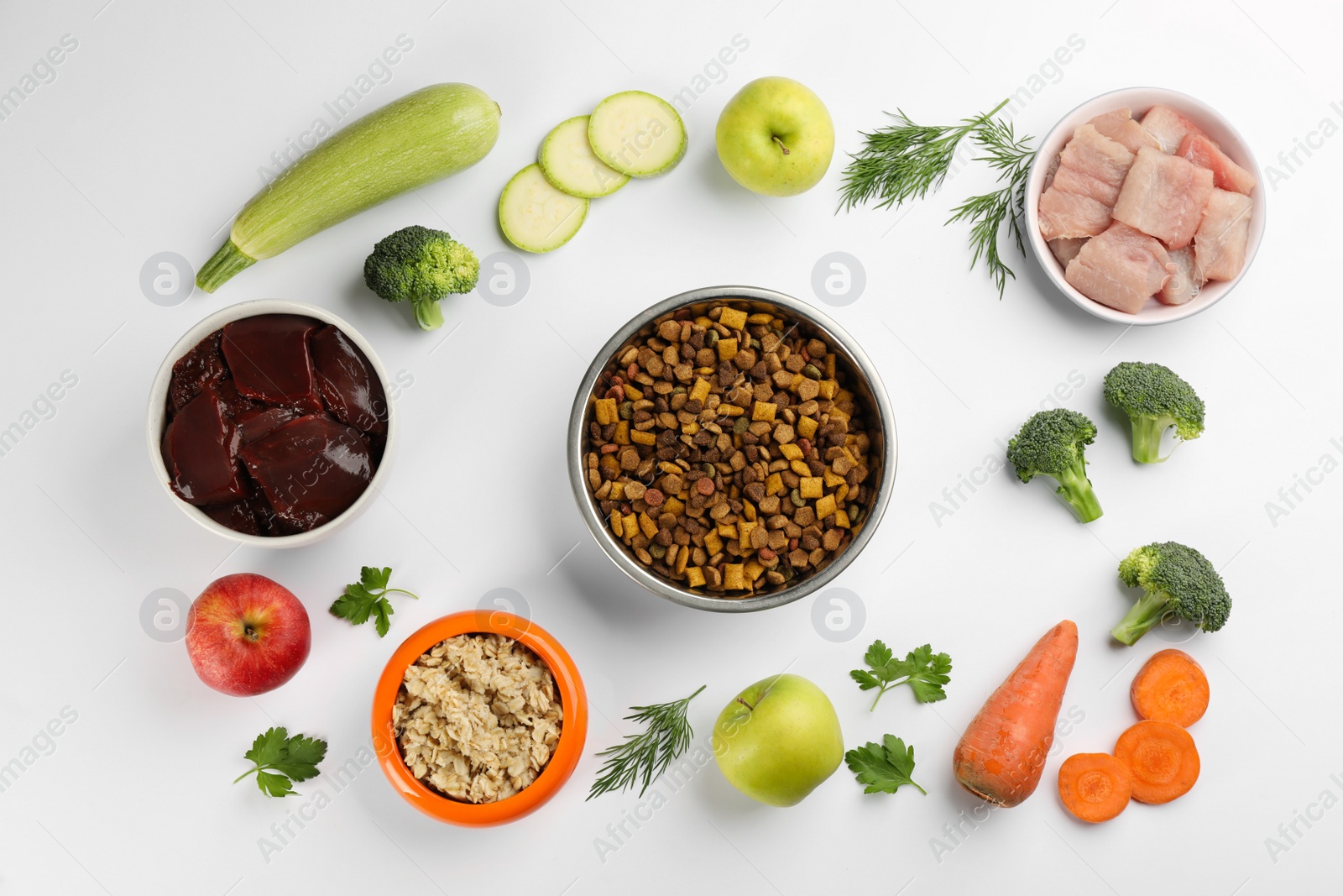 Photo of Pet food and natural ingredients on white background, top view