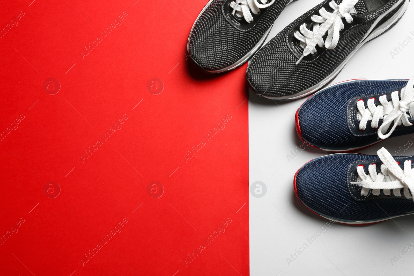 Photo of Flat lay composition of stylish training shoes on color background, space for text