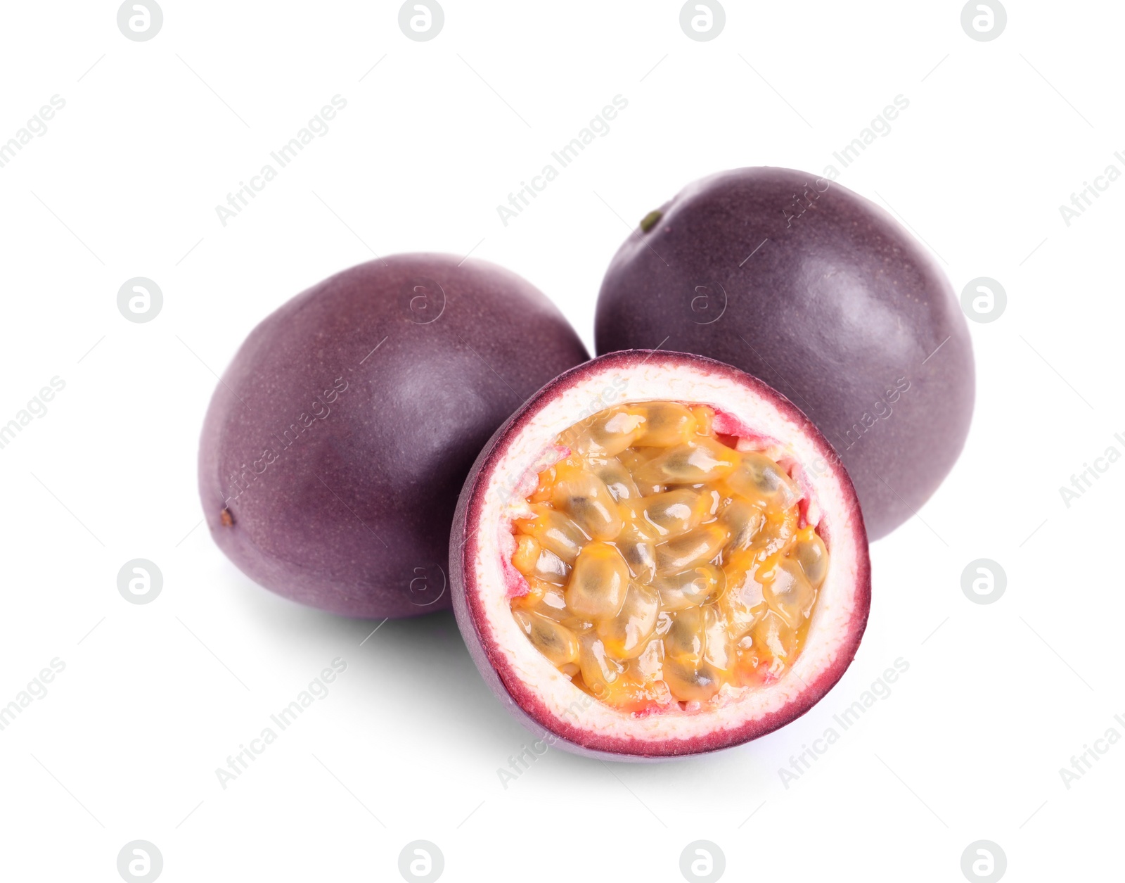 Photo of Cut and whole passion fruits isolated on white