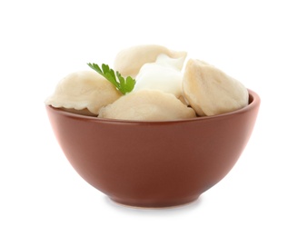 Tasty dumplings with sour cream and parsley in bowl isolated on white