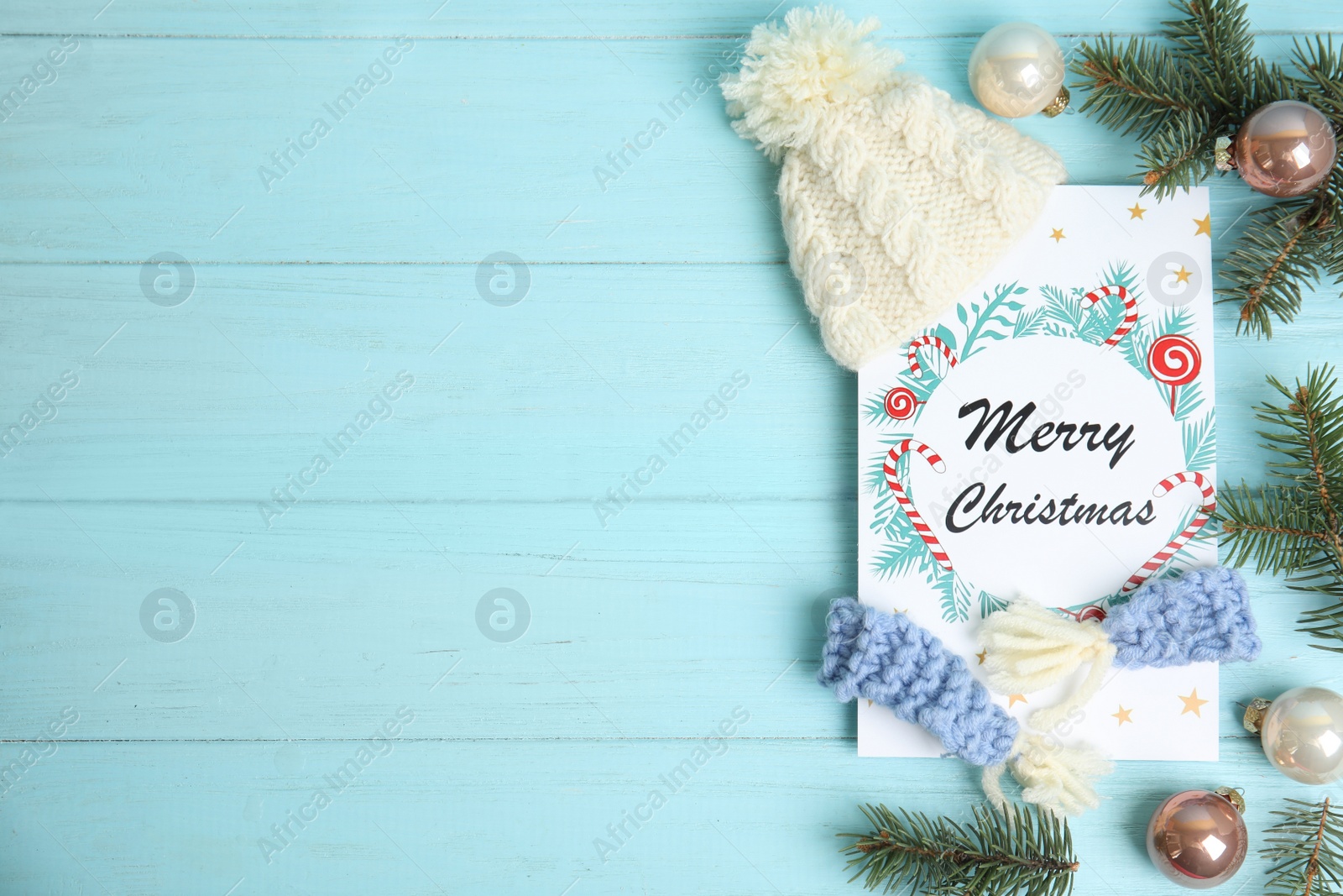 Photo of Flat lay composition with Christmas card and festive decor on light blue wooden background, space for text