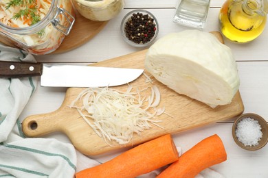 Photo of Cooking delicious sauerkraut soup. Fresh chopped cabbage and ingredients on white wooden table, flat lay