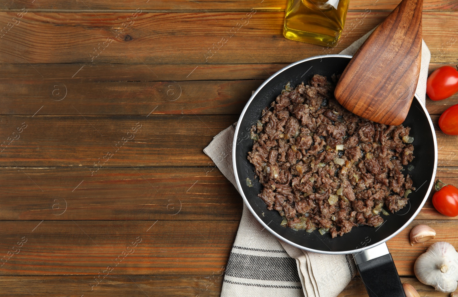 Photo of Fried minced meat with onion served on wooden table, flat lay. Space for text