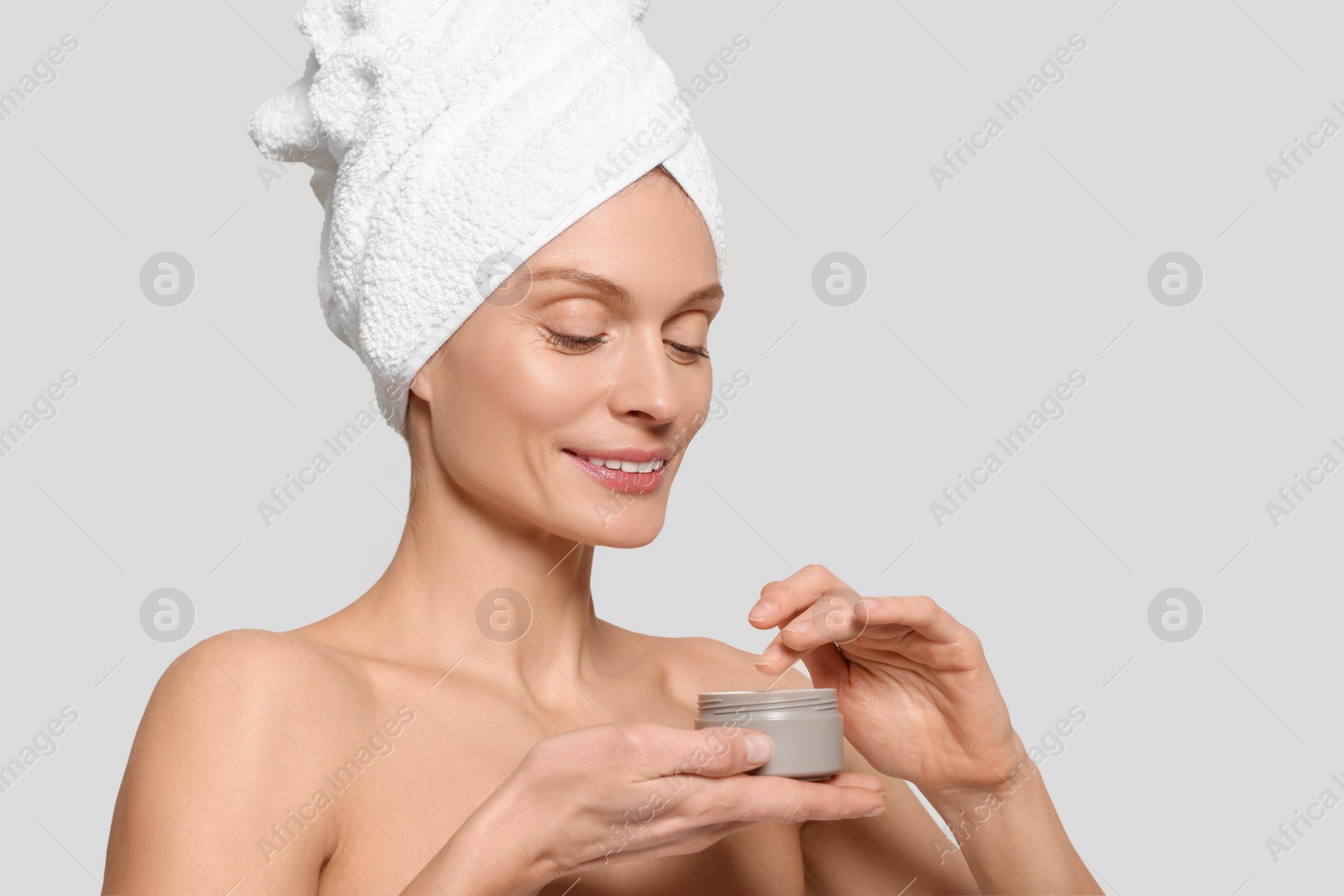 Photo of Woman with jar of body cream on white background, space for text