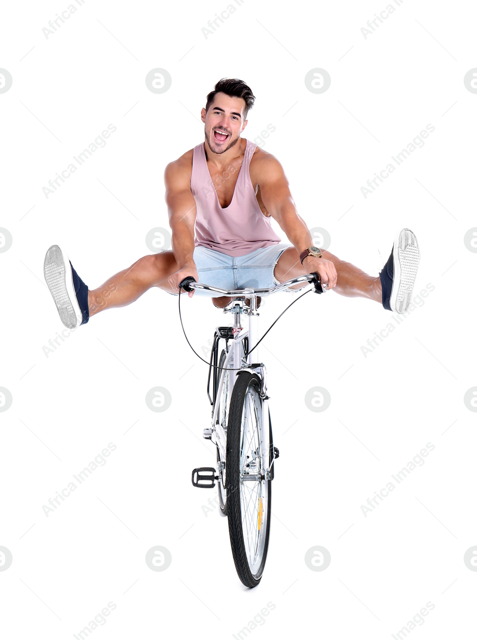 Photo of Handsome young hipster man riding bicycle on white background