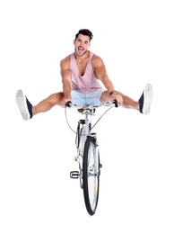 Handsome young hipster man riding bicycle on white background