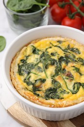 Photo of Delicious pie with spinach on table, closeup