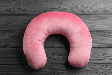 Image of Pink travel pillow on wooden background, top view
