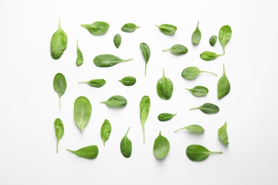 Photo of Fresh green healthy spinach leaves with water drops on white background, top view