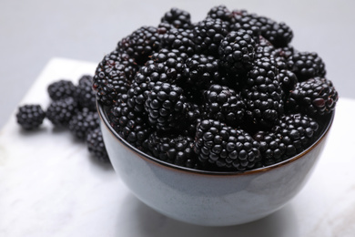 Fresh ripe blackberries in bowl on table, closeup