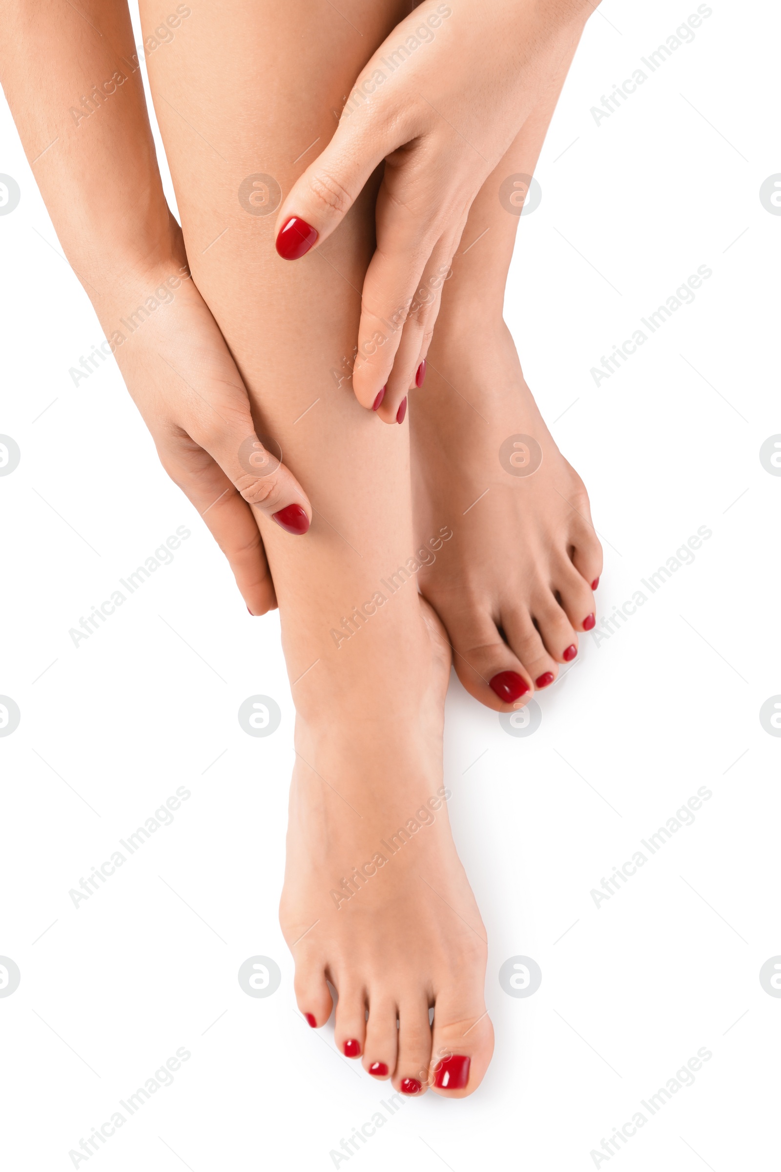 Photo of Woman with stylish red toenails after pedicure procedure isolated on white, top view