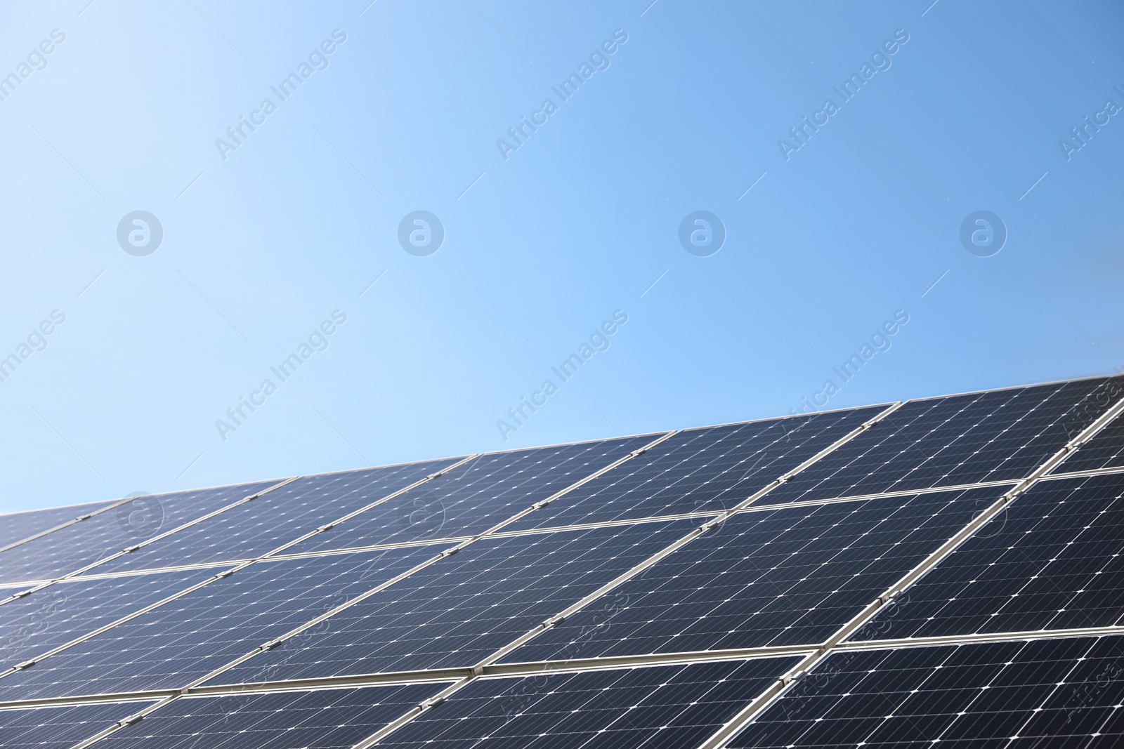 Photo of Solar panels installed outdoors, closeup. Alternative energy source