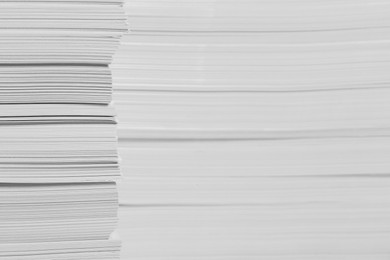 Photo of Stacks of paper sheets as background, closeup