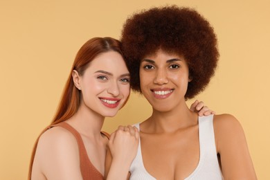 Portrait of beautiful young women on beige background