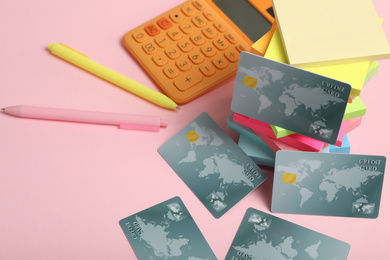 Credit cards and stationery on pink background