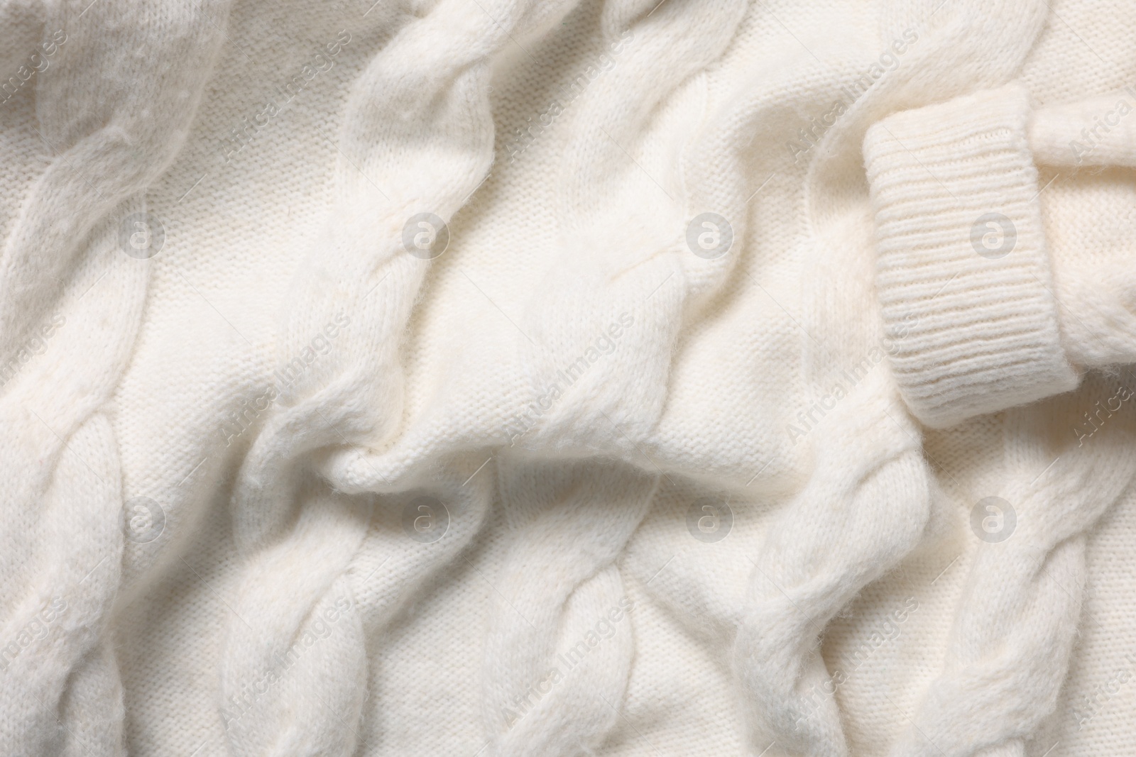 Photo of Texture of soft white knitted fabric as background, top view