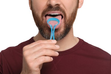 Photo of Man brushing his tongue with cleaner on white background, closeup