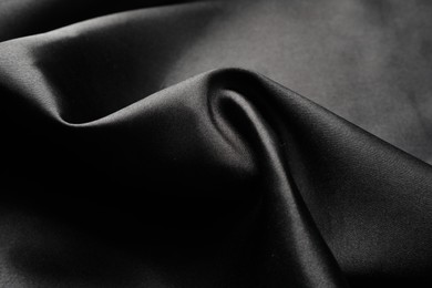 Crumpled black silk fabric as background, closeup