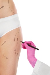 Doctor drawing marks on woman's body isolated on white. Cosmetic surgery