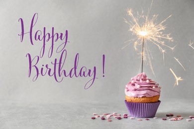 Image of Happy Birthday! Delicious cupcake with sparkler on grey background