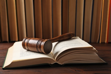 Wooden gavel and books on table. Law concept