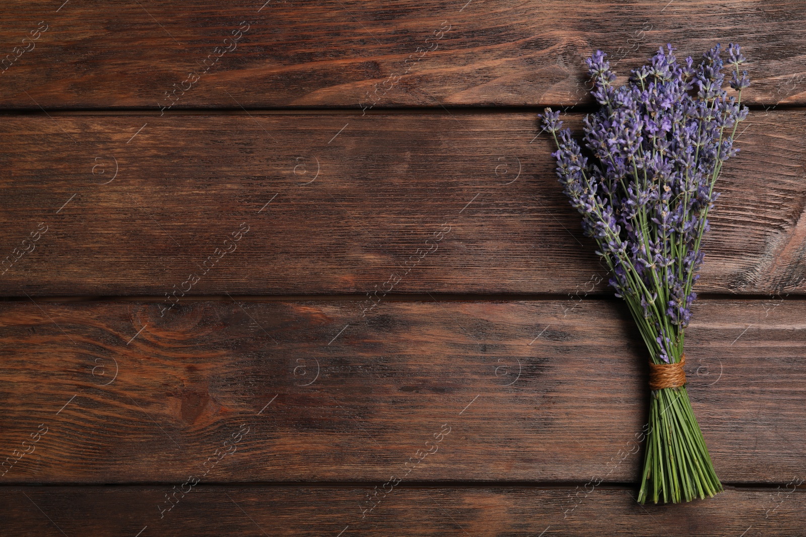 Photo of Beautiful lavender bouquet on wooden background, top view. Space for text