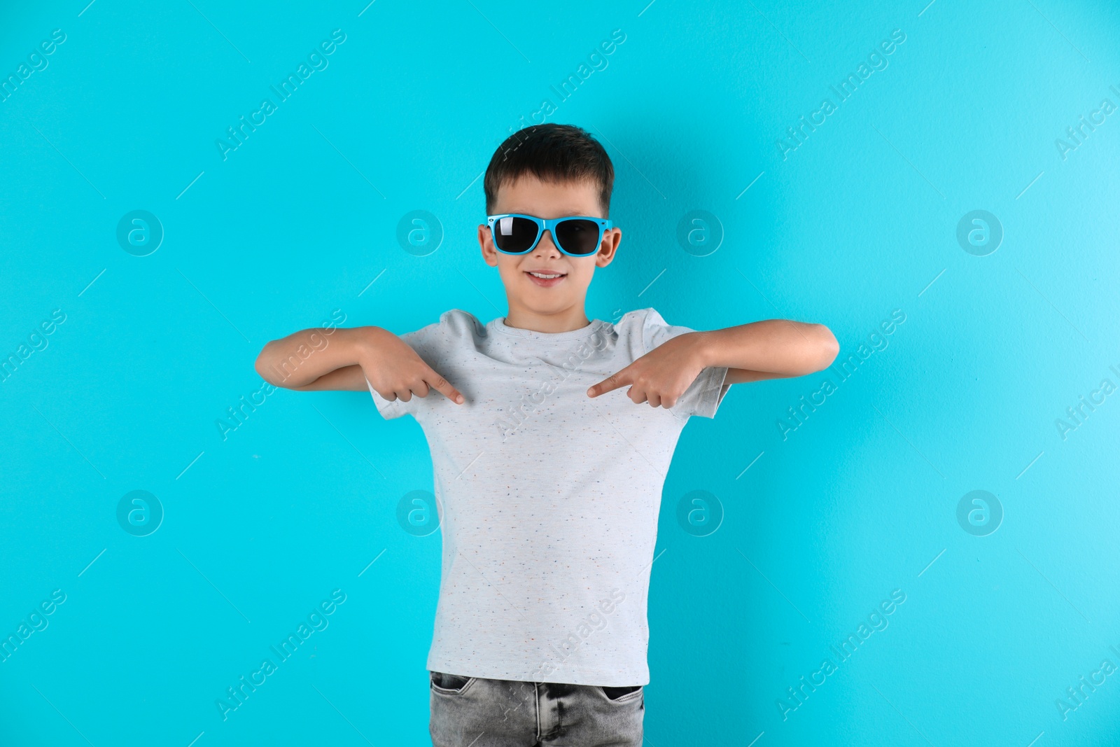 Photo of Little boy in t-shirt on color background. Mock-up for design