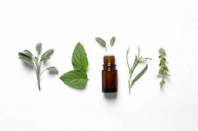 Bottle of essential oil and different herbs on white background, flat lay