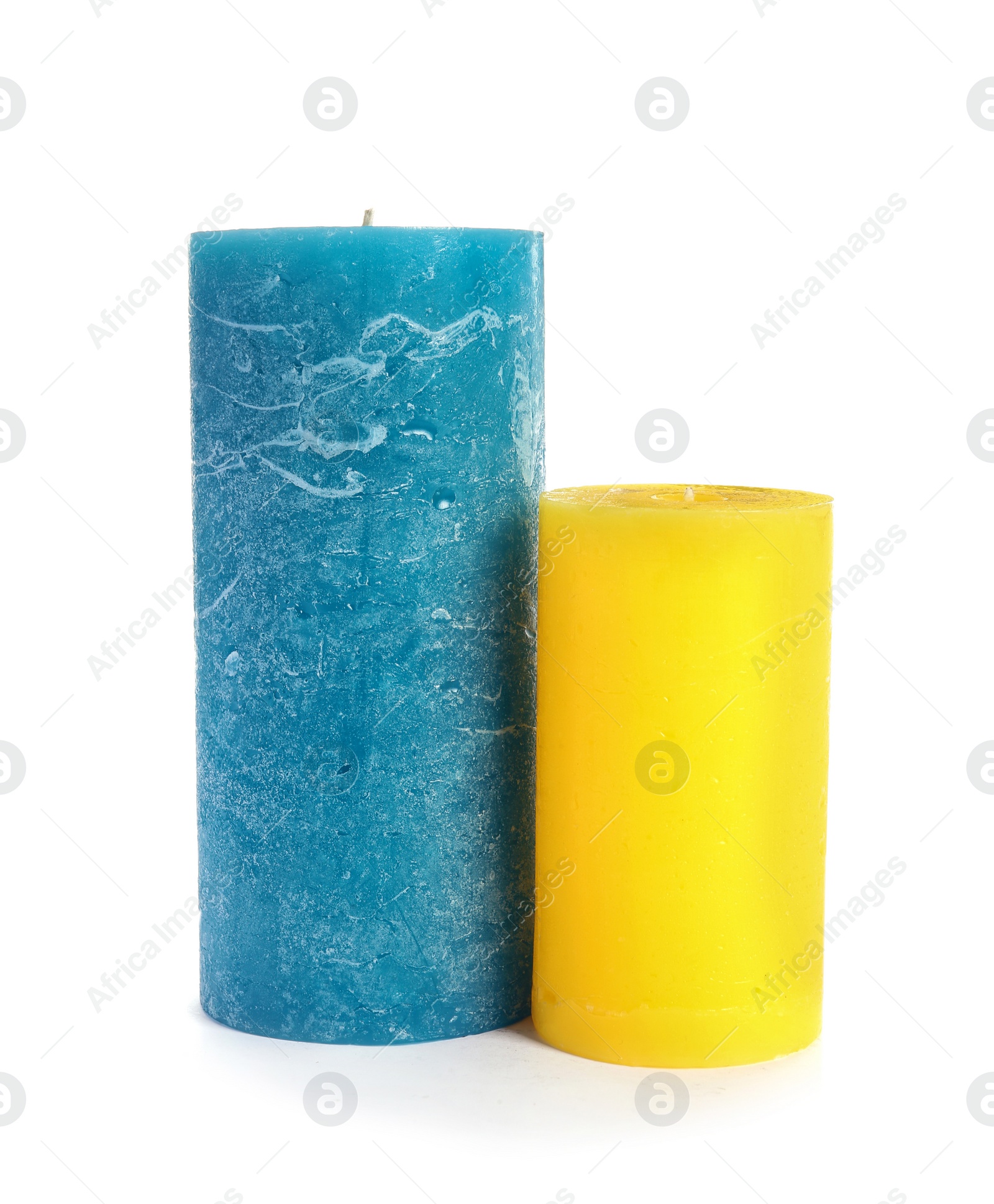 Photo of Two decorative wax candles on white background