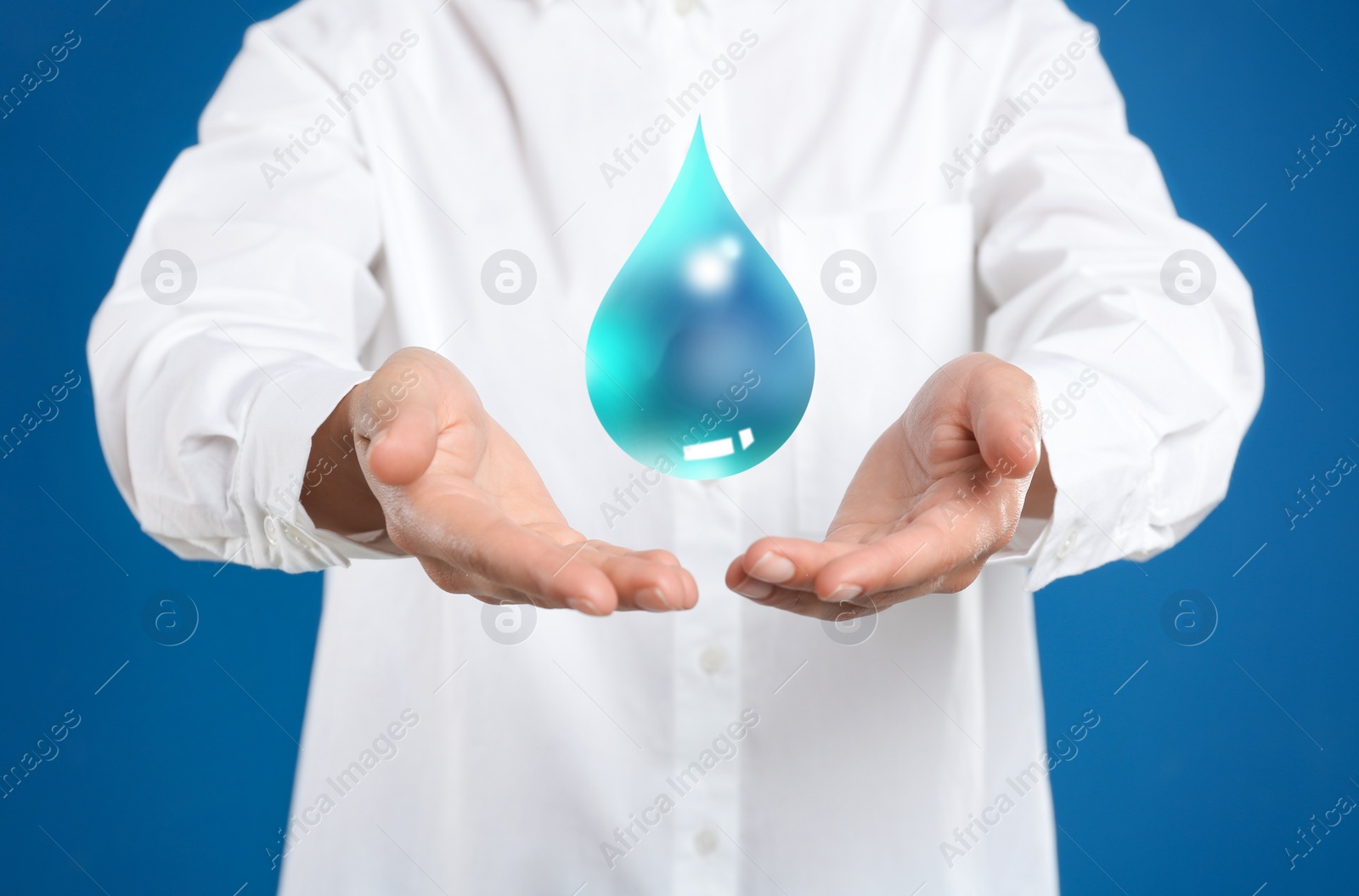 Image of Woman holding image of water drop on blue background, closeup