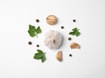 Flat lay composition with green parsley, pepper and garlic on white background