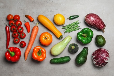 Photo of Flat lay composition of different fresh vegetables on grey table