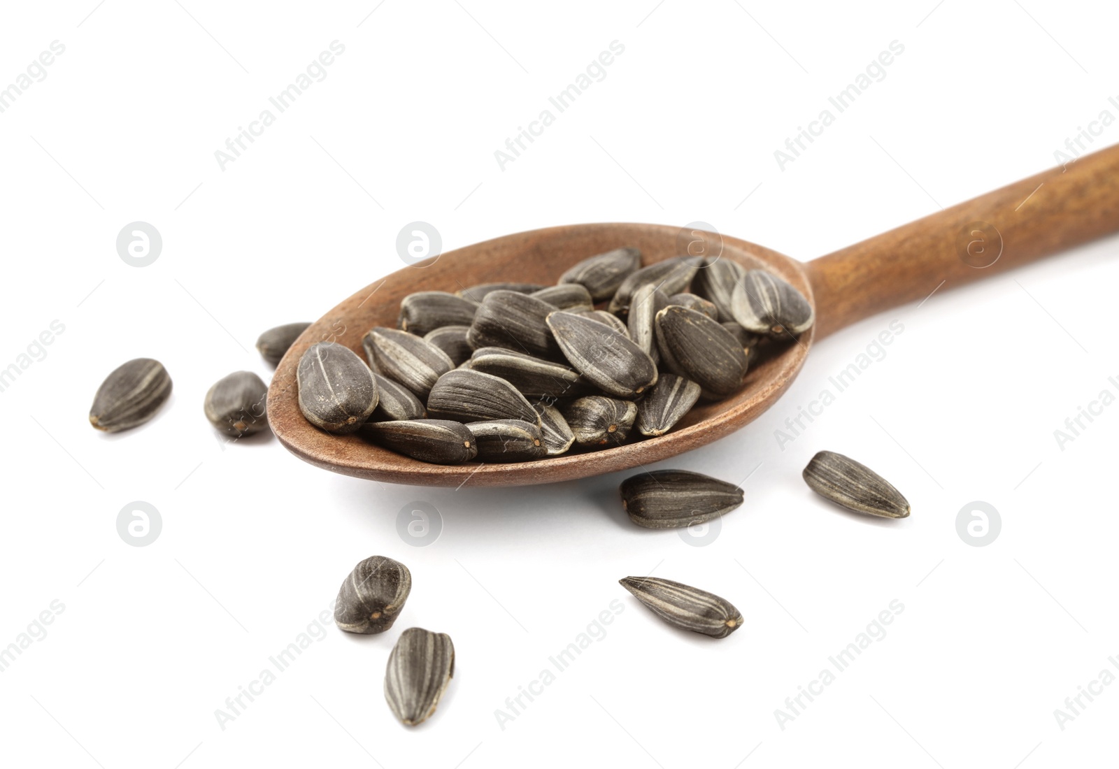 Photo of Raw organic sunflower seeds in wooden spoon isolated on white