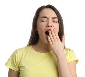 Young tired woman yawning on white background