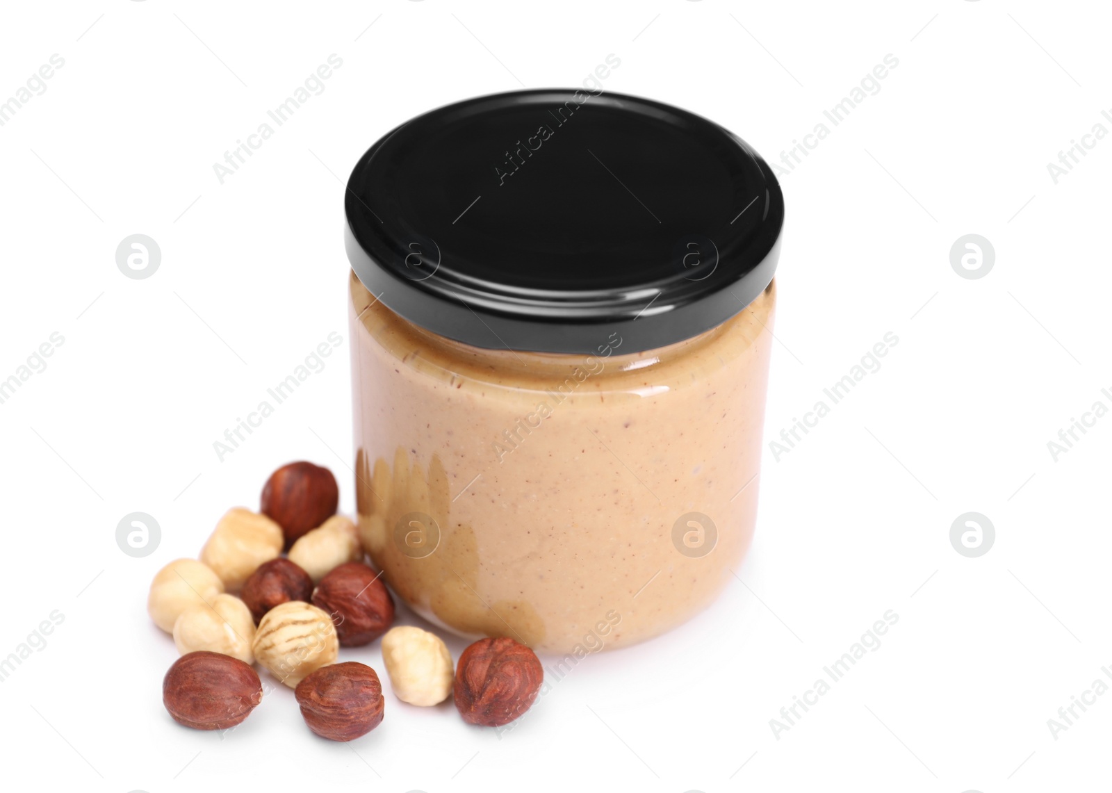 Photo of Tasty nut paste in jar and hazelnuts isolated on white