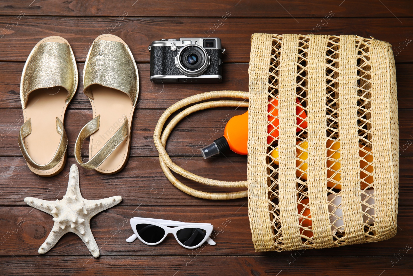 Photo of Flat lay composition with beach objects on wooden background