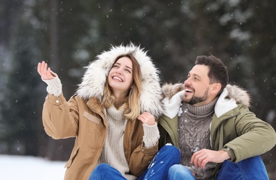 Photo of Couple spending time outdoors on snowy day. Winter vacation