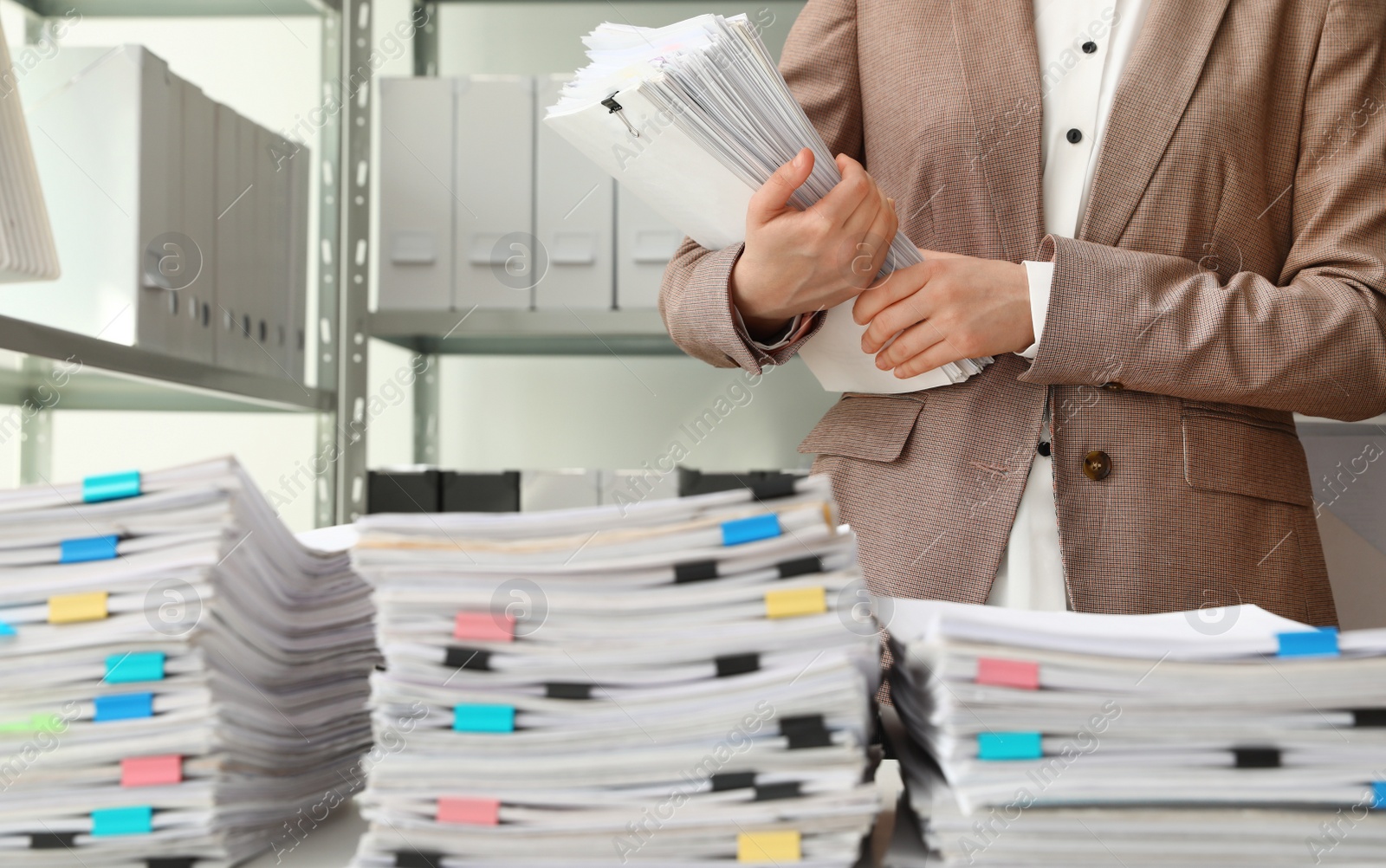 Photo of Female worker with documents in archive, closeup