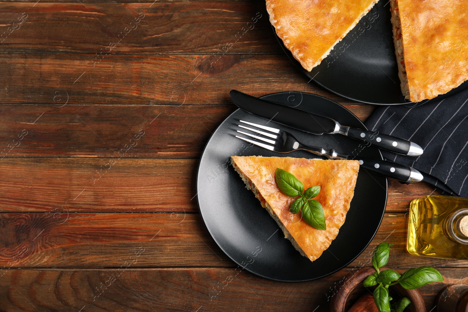 Photo of Delicious pie with meat and basil on wooden table, flat lay. Space for text