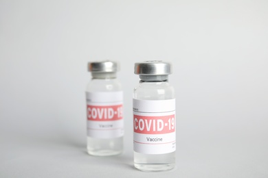 Photo of Vials with coronavirus vaccine on light background