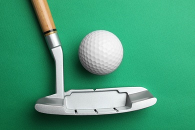 Photo of Golf ball and club on color background, flat lay. Sport equipment
