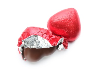 Heart shaped chocolate candies in red foil on white background, top view