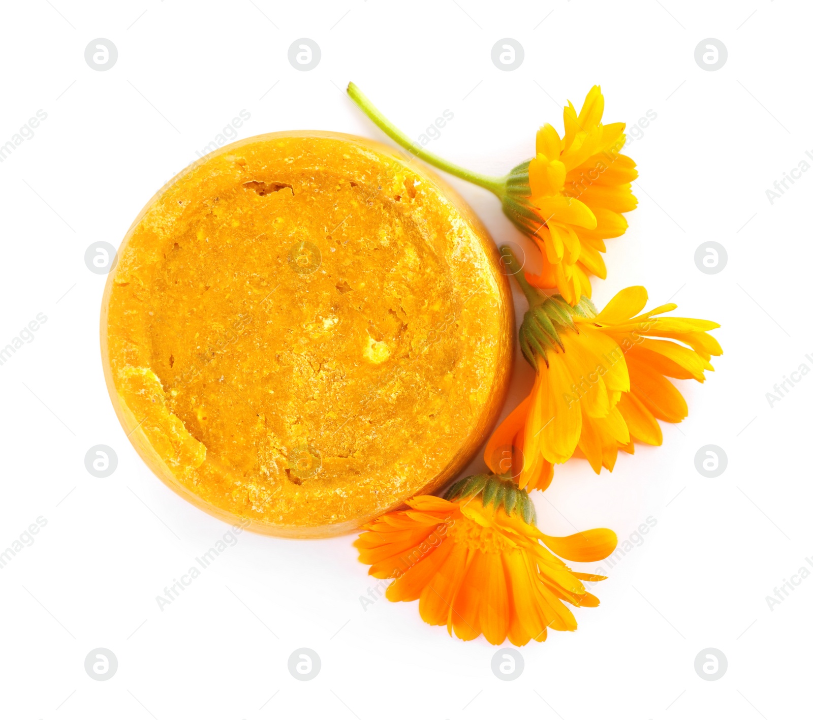 Photo of Yellow solid shampoo bar and flowers on white background, top view. Hair care