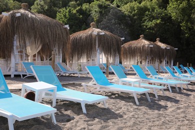 Sandy beach with loungers and huts at resort