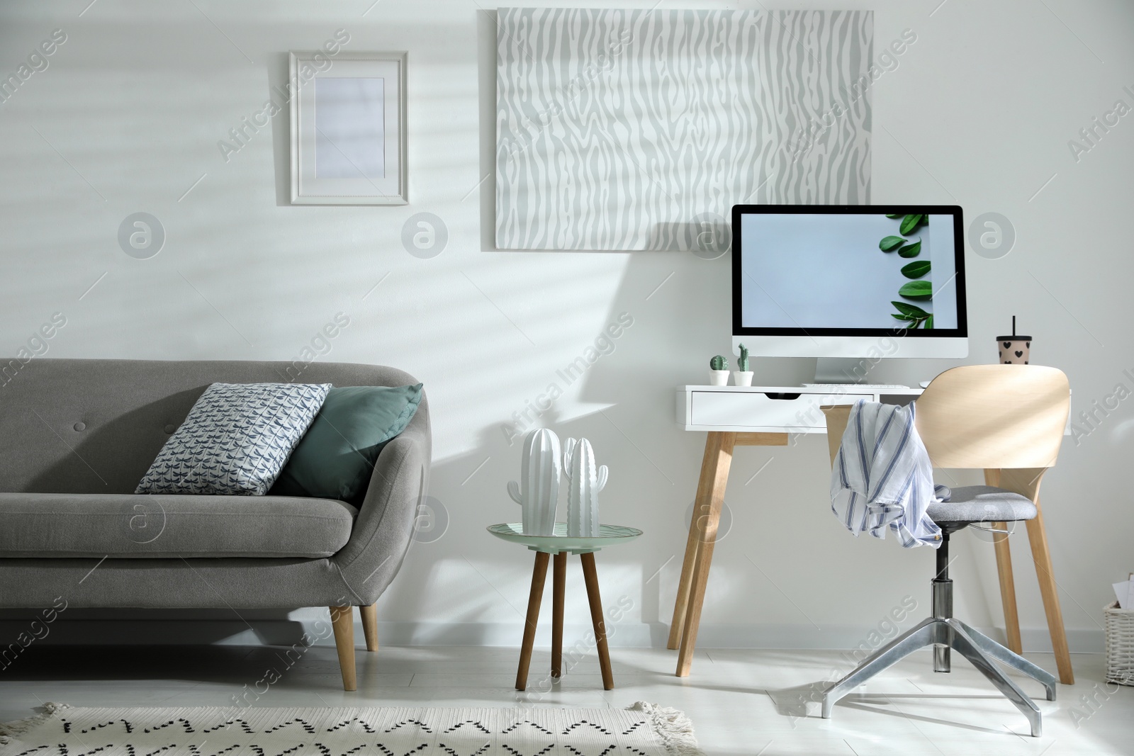 Photo of Comfortable office chair near desk with modern computer indoors